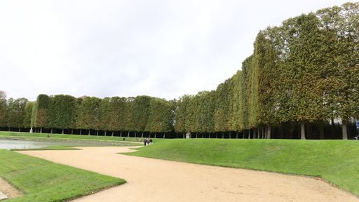 A beautiful view of garden of the Palace of Versailles on a cloudy day in Paris, France