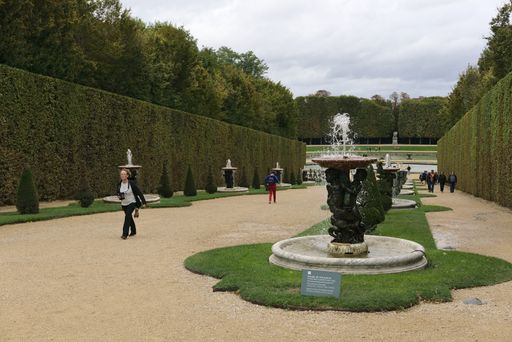 A beautiful view of garden of the Palace of Versailles on a cloudy day in Paris, France