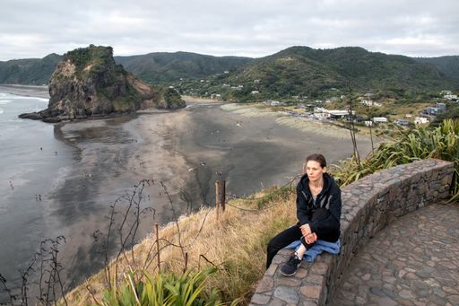 Woman tourist at Piha Beach lookout. Auckland, New Zealand - January 1, 2020