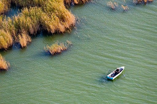 An aerial view of a fishing boat on Lake Chany in Novosibirsk, Russia