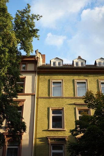 A vertical shot of the residential building under the blue sky