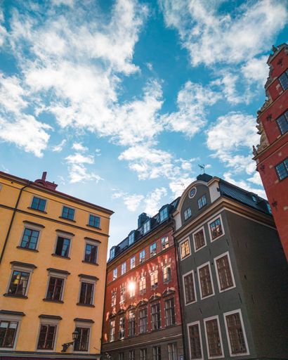 Beautiful colorful buildings at Stortorget square in Gamla Stan under a blue cloudy sky on a sunny day