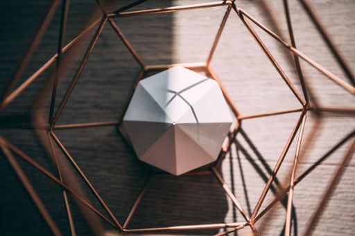 A top view of an octagon geometric shape made of concrete inside a metallic octagon under the sunlight