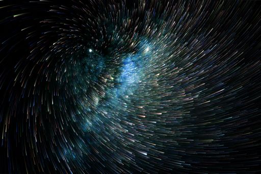 A long exposure of swirling light sparks on a dark background