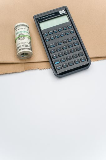 compact business calculator on a brown paper and white background with copy space