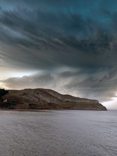 The Great Orme on the North-West of the town of Llandudno in UK under a gloomy sky