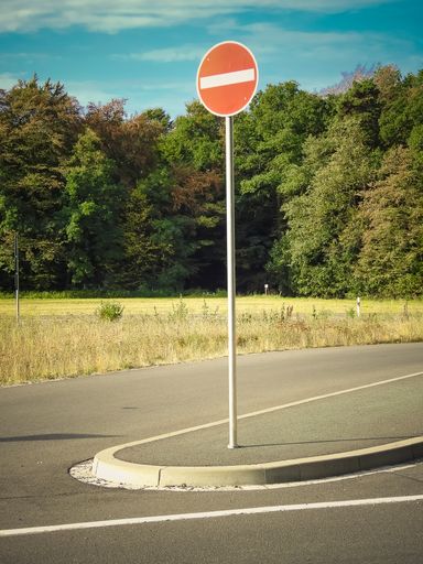 A vertical shot of a route with a prohibiting sign