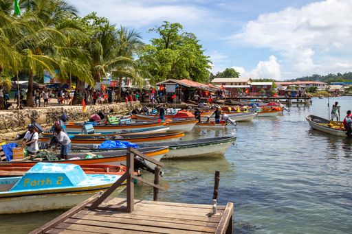 Boats moored along the shoreline in front of Gizo Market in Western Province of the Solomon Islands.