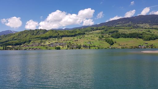 A mesmerizing view of water lake Lake Sarnen and green cliffs against a cloudy sky in Switzerland