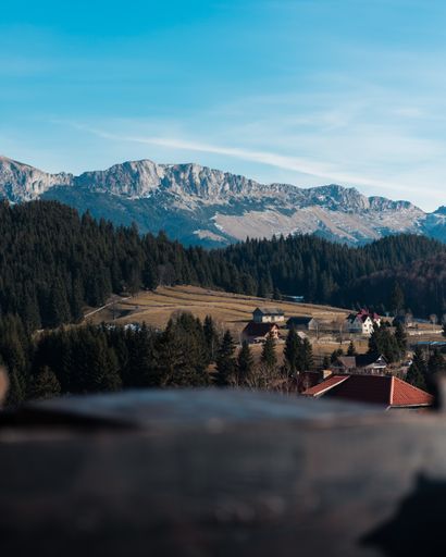 A stunning view of the Carpathian Mountains near Brasov, Romania under a blue sky