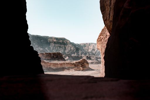 A beautiful view of the rocks and cliff in a desert captured from inside a cave