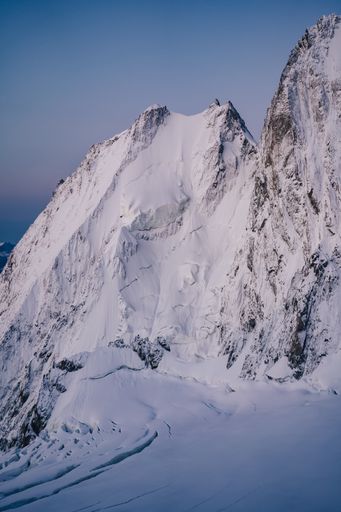 Alpine landscape, wall of ice and snow during sunrise.