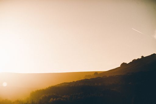 A beautiful shot of brown and green lowlands in the countryside at sunset during spring