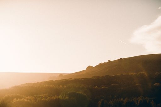 A beautiful shot of brown and green lowlands in the countryside at sunset during spring
