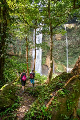 Hikers appro the scenic Tenaru Falls during a hike outside of Honiara, the capital city of the Solomon Islands.