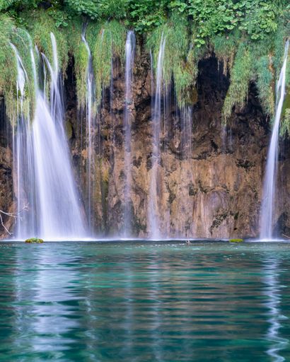 A vertical shot of a waterfall at Plitvice Lakes National Park, Croatia