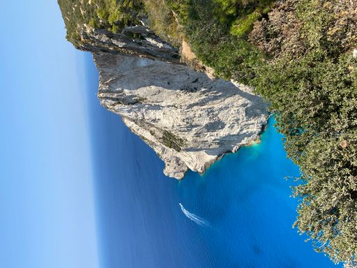 A vertical shot of a scenic view of a beautiful sea with rocks and cliffs in Zakynthos, Greece