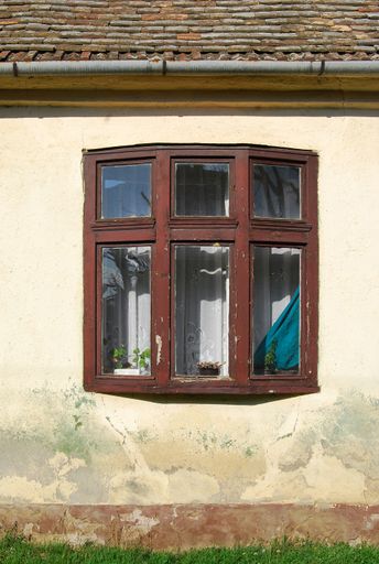 An old wooden window on the wall of an old house in Novi Kozjak, Banat, Serbia