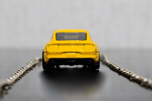 A closeup shot of a yellow toy car