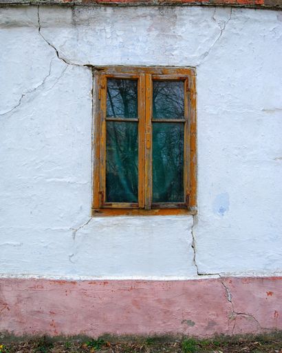 Anld wooden window on the wall of an old house in Stari Lec, Banat