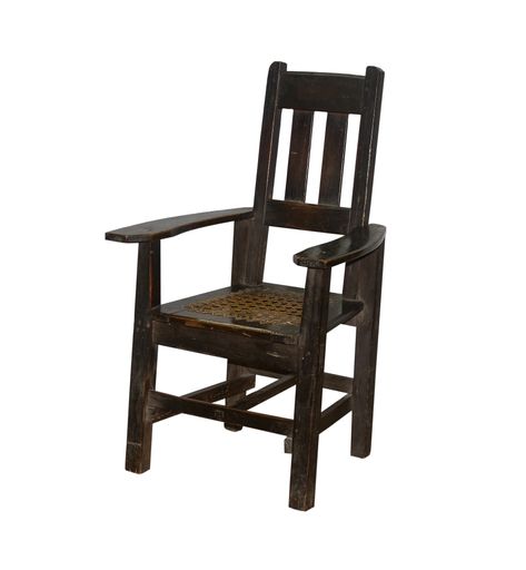 A vertical shot of a wooden vintage chair under the lights isolated on a white background