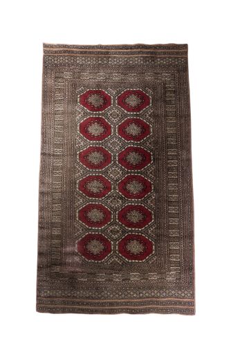 A closeup of a vintage carpet with beautiful ornaments isolated on a white background
