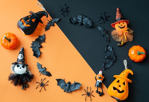 A Halloween composition decorated with pumpkins and typical ornaments - copy space