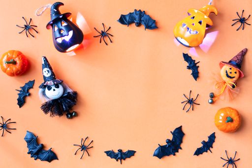 A Halloween composition decorated with pumpkins and typical ornaments - copy space