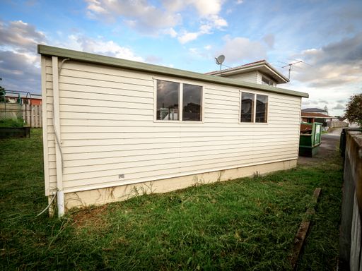 View of attached suburban garage with weatherboards