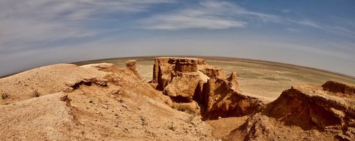 A panoramic shot of the beautiful canyon in a desert on a sunny day
