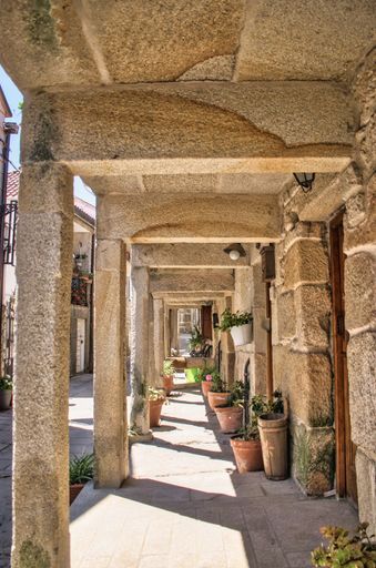 A vertical shot of a roadside in the medieval village Combarro, Spain