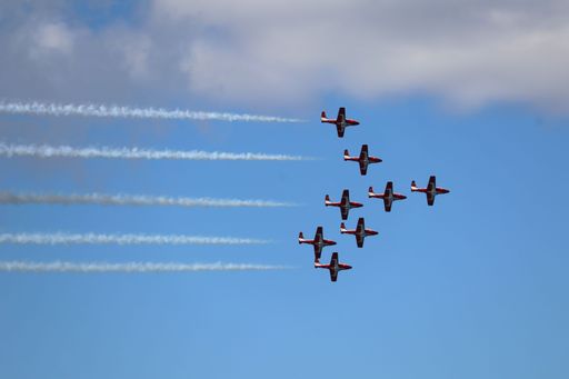 Belly view of Canadian Snowbirds flying in formation with smoke trails at San Francisco Fleet Week
