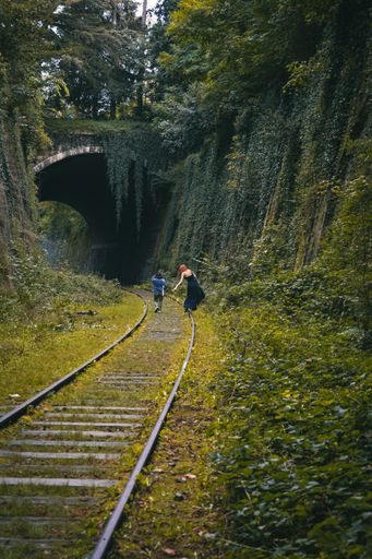 A vertical shot of people walking on a railway