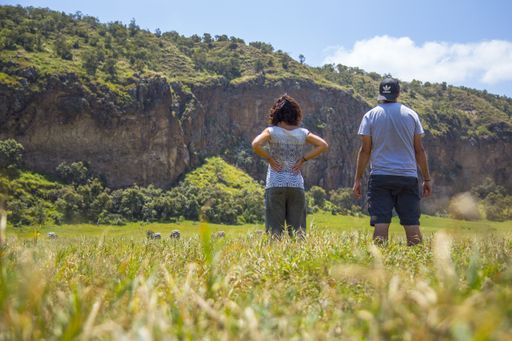 A wide angle shot of two people standing in Naivasha Hells Gate National Park, Kenya