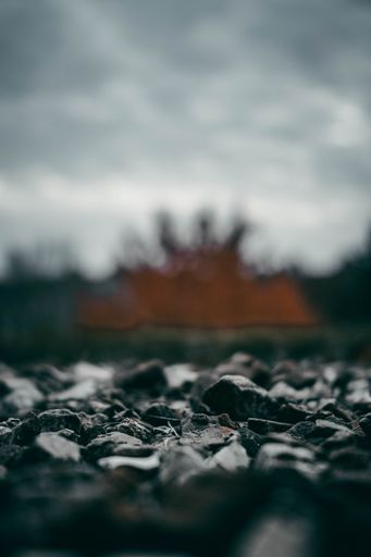 A shallow focus of rocky coastline with rocks with a blurred hazy sky