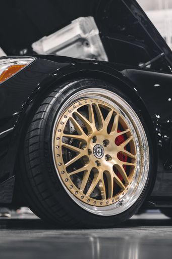 A closeup shot of the tire of a luxury car from a car show in Epping NH, United States