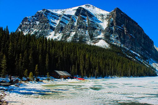 A frozen Lake Louise with mountains range background in Banff Alberta, Canada during winter