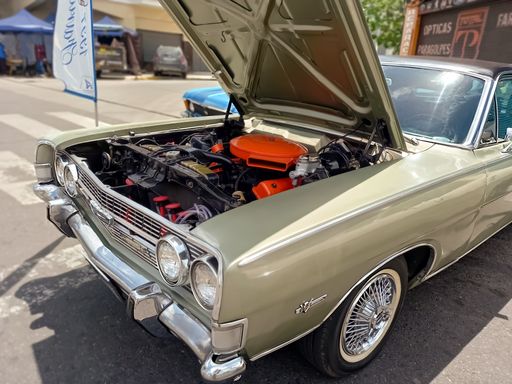 Engine of a luxury beige Ford Fairlane V8 292 1970s sedan. Sporty and stylish built in Argentina. Hood open. Expo Warnes 2021 classic car show.