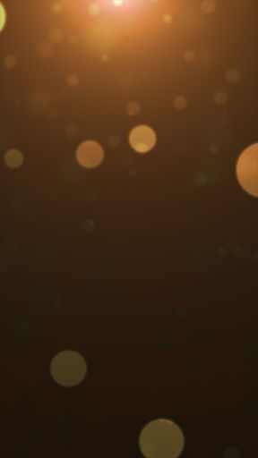 Abstract bokeh lights on a warm brown background creating a soft, dreamy atmosphere.