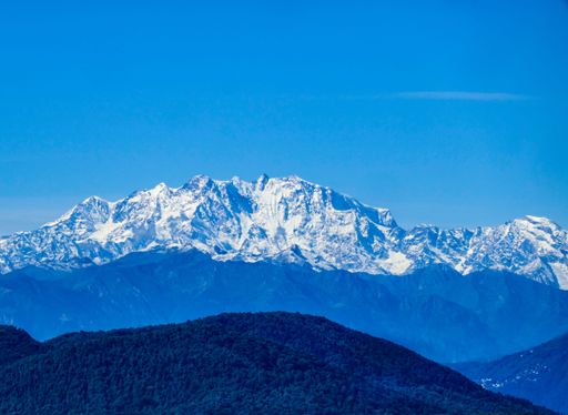 Snow-capped mountain range under a clear blue sky, showcasing natural beauty and serene landscape.
