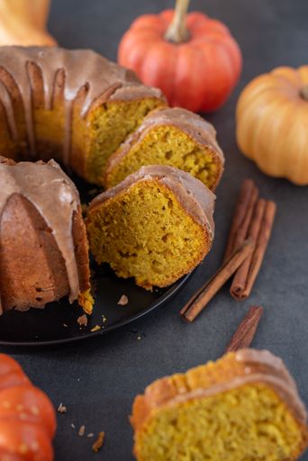 A close-up shot of a sliced fresh homemade delicious pumpkin Bundt cake on a