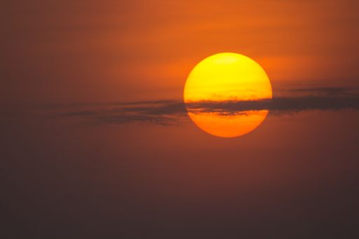 A beautiful view of the afternoon red sun with a cloudy sky - concept: mysterious