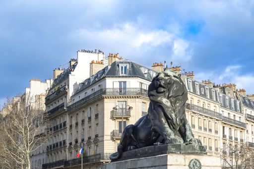 Paris, France, beautiful lion place Denfert-Rochereau in the 14e arrondissement, with typical buildings