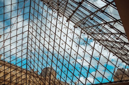 A low angle shot of the beautiful glass ceiling of the Louvre museum captured in Paris, France