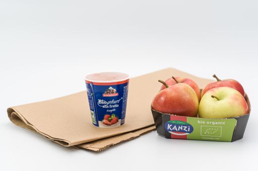 isolated carton paperboard tray with tasty bio organic apples on a white tabletop with copy space