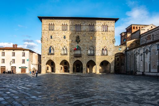 A view of Piazza del Duomo, the main square of Pistoia historic center, Tuscany, Italy against a blue sky