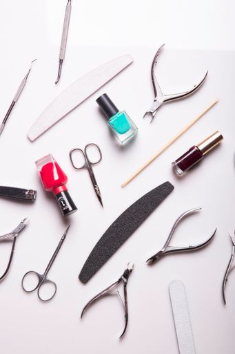 A closeup of nail care products on a gray surface