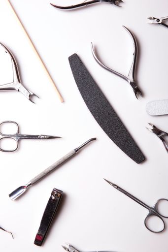 A closeup of nail care products on a gray surface