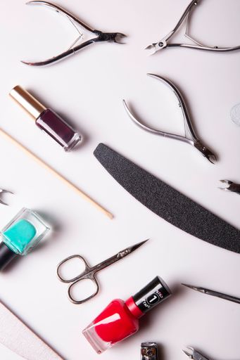 A closeup of nail care products on a gray surface