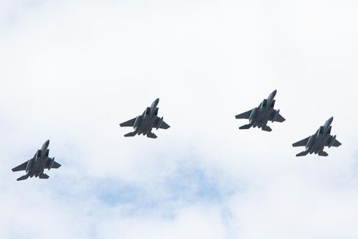 A low angle shot of a row of jets flying over Worcester